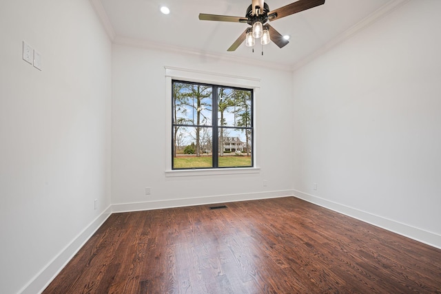 unfurnished room featuring dark wood-style floors, visible vents, ornamental molding, ceiling fan, and baseboards