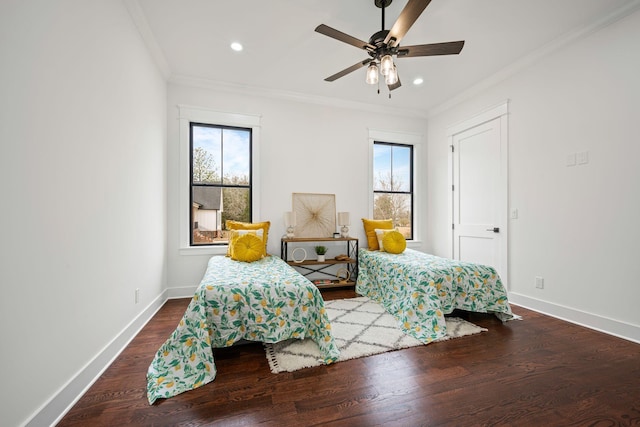 bedroom featuring baseboards, multiple windows, wood finished floors, and crown molding