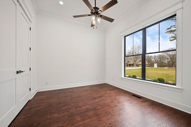 unfurnished bedroom featuring visible vents, dark wood finished floors, and crown molding