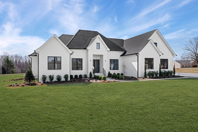 modern farmhouse with roof with shingles, board and batten siding, and a front yard