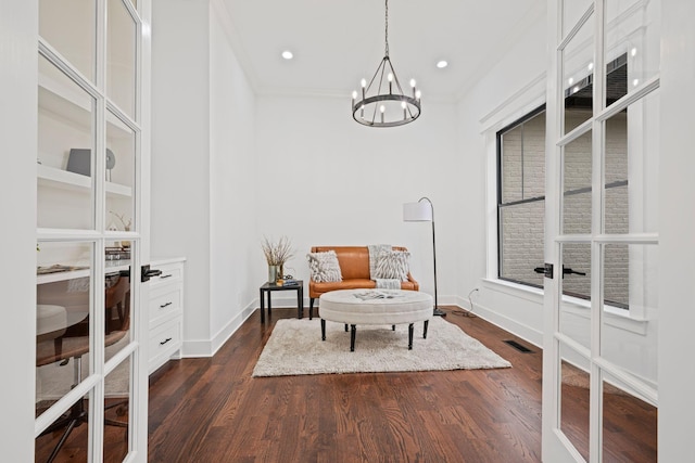 living area featuring ornamental molding, dark wood finished floors, visible vents, and baseboards