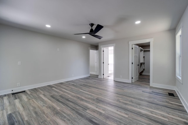 unfurnished bedroom with baseboards, visible vents, wood finished floors, and recessed lighting