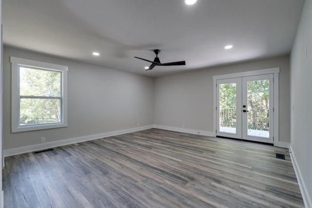 spare room featuring french doors, recessed lighting, visible vents, wood finished floors, and baseboards