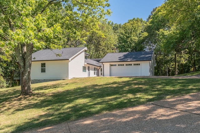 exterior space with a garage and a yard