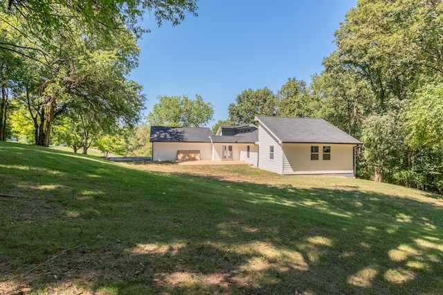 rear view of property featuring a yard