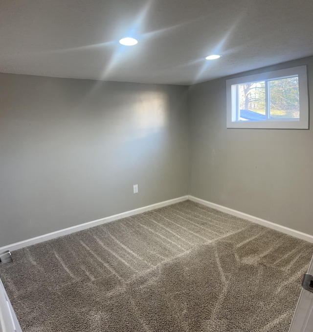 carpeted spare room featuring recessed lighting and baseboards