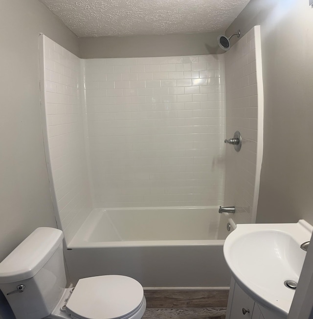 bathroom with a textured ceiling, toilet, and wood finished floors