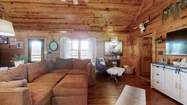 living area featuring high vaulted ceiling, dark wood-type flooring, and wooden walls