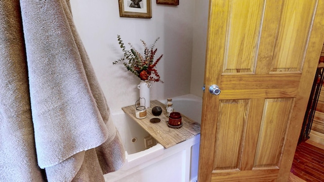 full bathroom featuring a jetted tub