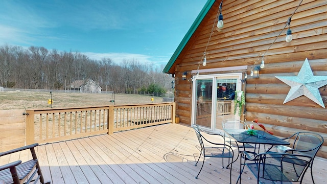 wooden deck featuring outdoor dining space and fence