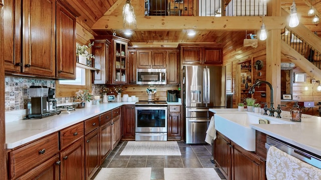 kitchen with wooden ceiling, glass insert cabinets, stainless steel appliances, light countertops, and backsplash