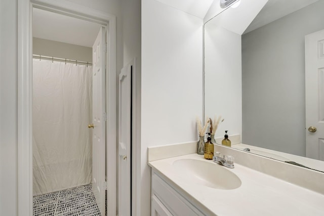 full bath featuring curtained shower, vanity, and tile patterned floors