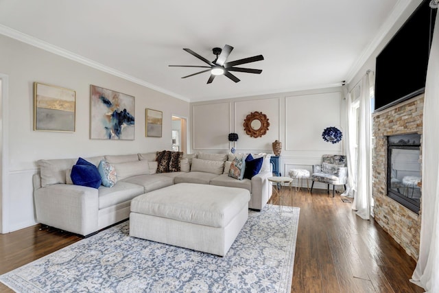 living area featuring ornamental molding, a ceiling fan, and dark wood-style floors