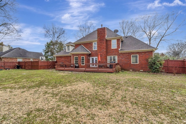 rear view of property with brick siding, a yard, crawl space, a deck, and a fenced backyard