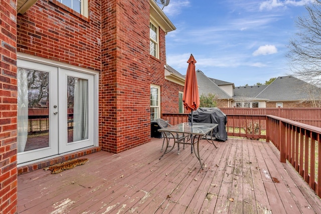 wooden deck with french doors and area for grilling