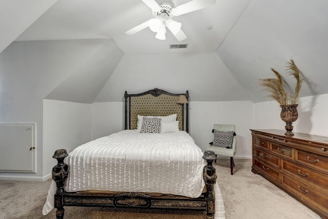 bedroom with light carpet, visible vents, vaulted ceiling, and a ceiling fan