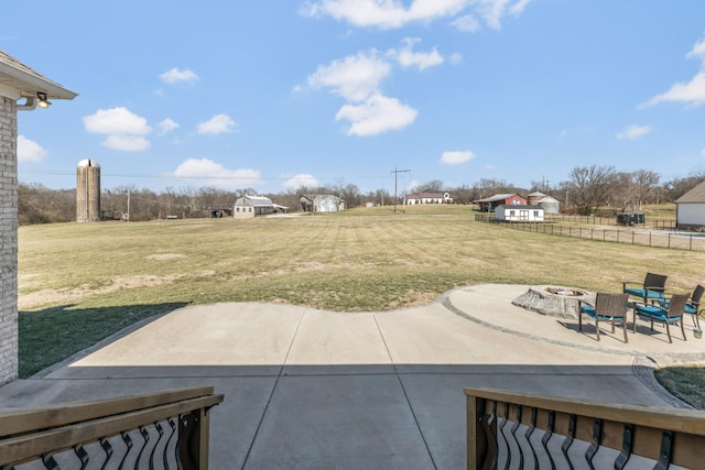 view of patio / terrace with fence and a fire pit