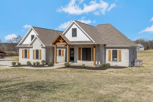 view of front facade with board and batten siding, cooling unit, roof with shingles, and a front yard