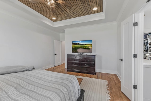 bedroom featuring wood ceiling, a raised ceiling, baseboards, and wood finished floors