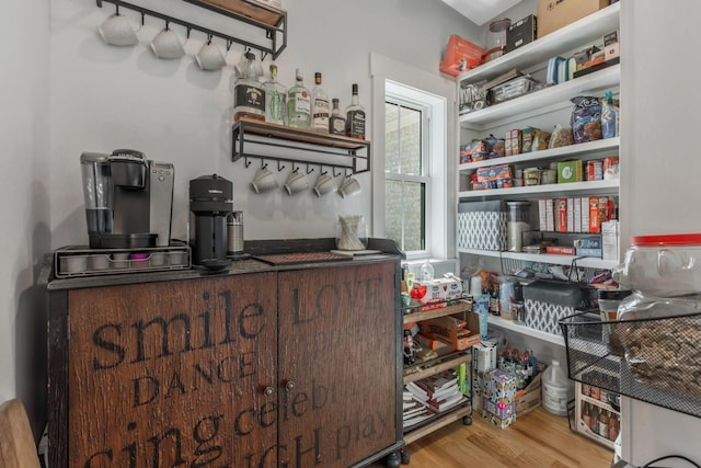 interior space with a dry bar and wood finished floors