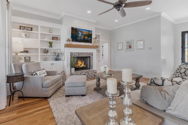 living area featuring a fireplace, recessed lighting, ornamental molding, wood finished floors, and baseboards