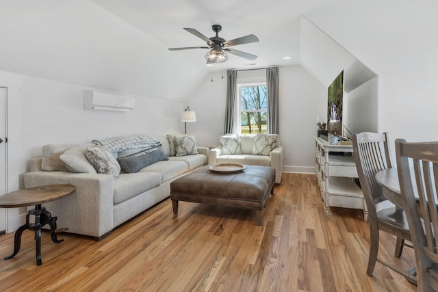 living area with a wall unit AC, light wood-style floors, ceiling fan, and vaulted ceiling