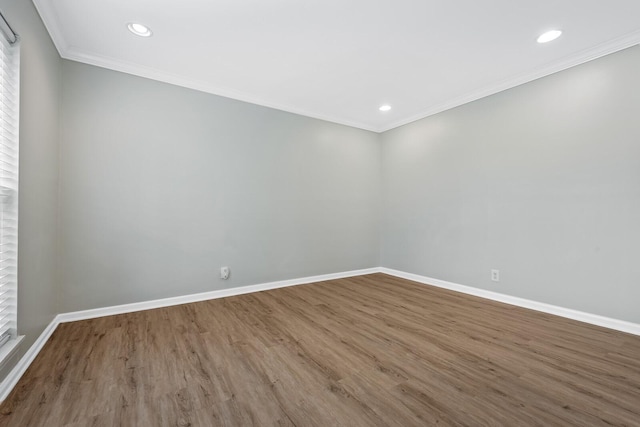 empty room featuring recessed lighting, baseboards, wood finished floors, and ornamental molding