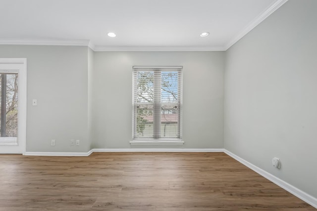 unfurnished room featuring baseboards, crown molding, and wood finished floors