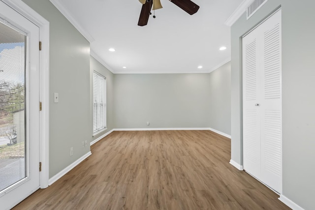 interior space with ornamental molding, a wealth of natural light, and baseboards