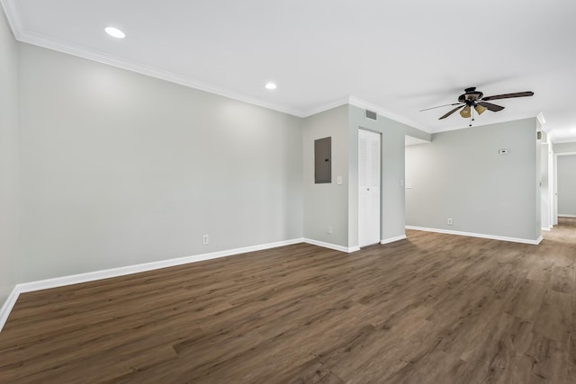 spare room featuring electric panel, baseboards, ceiling fan, ornamental molding, and dark wood-style flooring