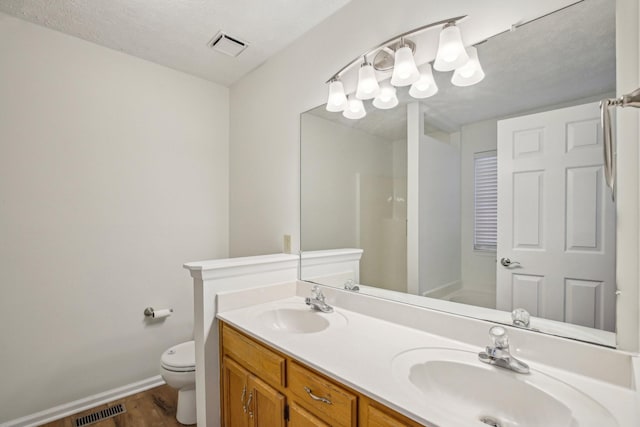 bathroom with visible vents, a sink, and toilet