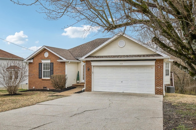 single story home with crawl space, brick siding, an attached garage, and concrete driveway