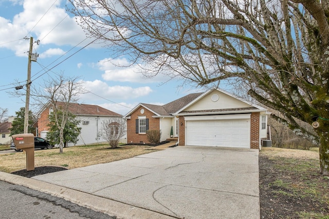 ranch-style home featuring a garage, central AC, brick siding, driveway, and crawl space