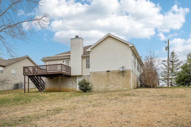 back of property with central AC unit, stairs, a lawn, a wooden deck, and a chimney