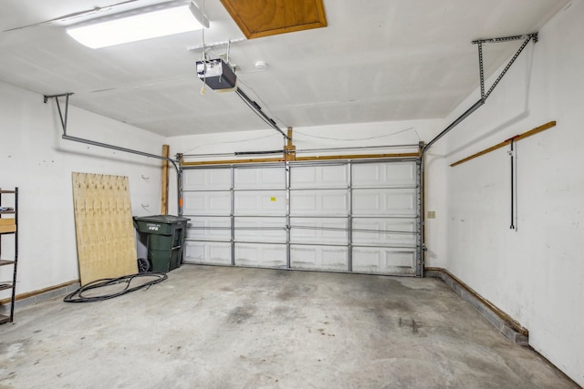 garage with a garage door opener and baseboards