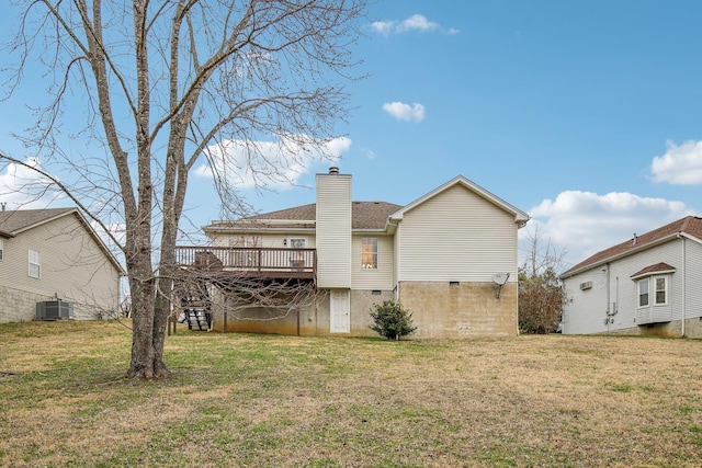 rear view of house with cooling unit, a yard, a chimney, and a wooden deck