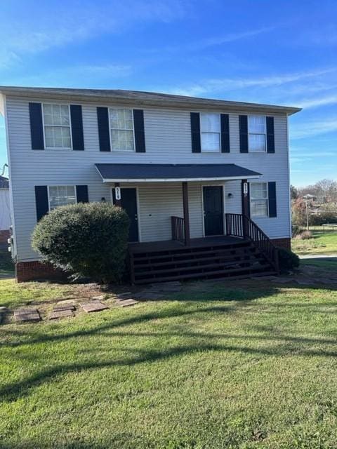 view of front of property with a porch and a front yard