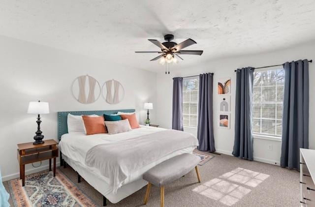 bedroom featuring light colored carpet, ceiling fan, and baseboards