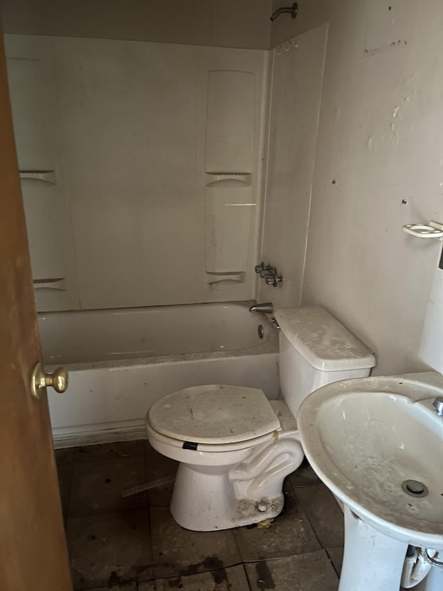 bathroom featuring tub / shower combination, a sink, and toilet