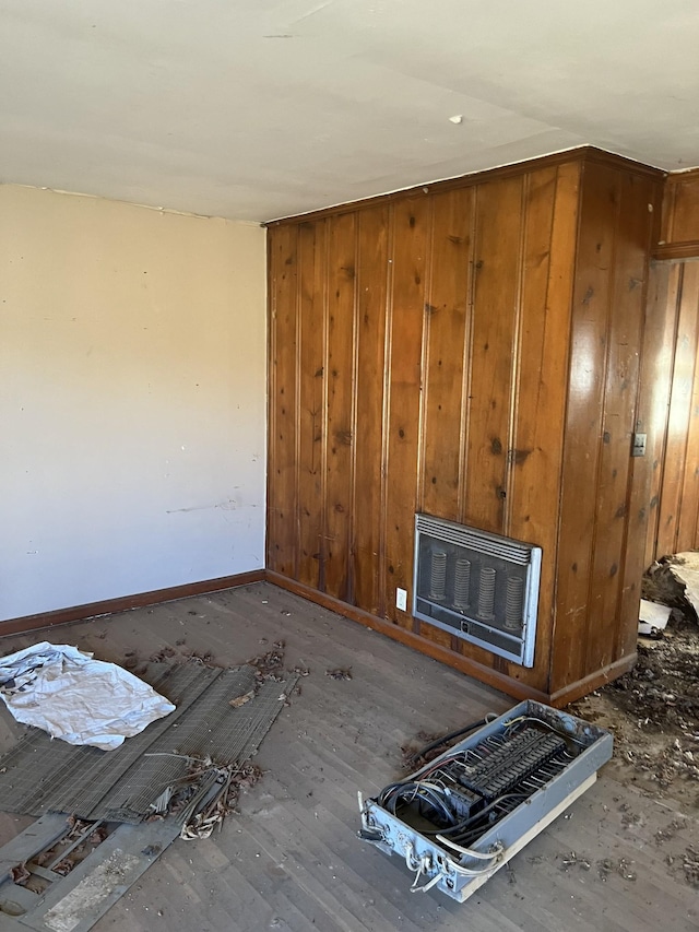 unfurnished living room featuring heating unit and baseboards