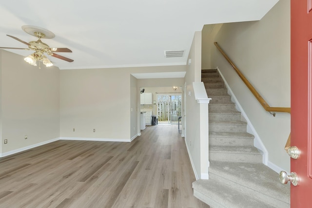 foyer entrance with light wood-type flooring, visible vents, stairway, and baseboards