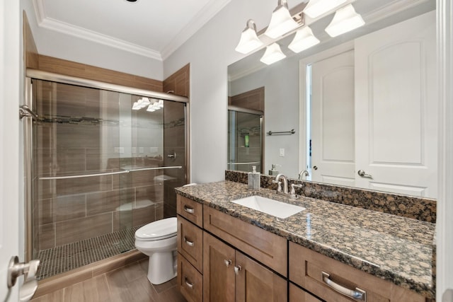 full bath with vanity, crown molding, toilet, and a stall shower