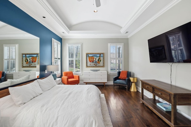 bedroom featuring crown molding, wood finished floors, baseboards, and a tray ceiling