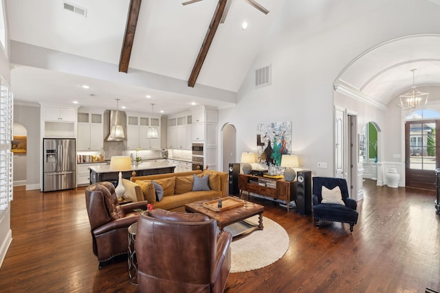 living room with visible vents, arched walkways, a notable chandelier, and dark wood finished floors