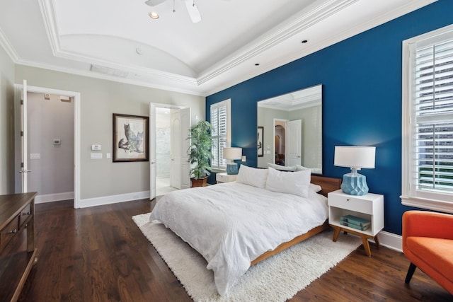 bedroom with multiple windows, wood finished floors, and baseboards