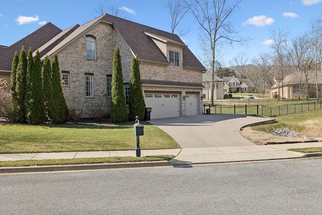 view of property exterior with a lawn, driveway, fence, a garage, and brick siding