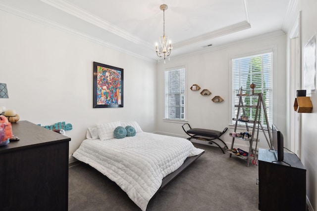 bedroom featuring visible vents, ornamental molding, a tray ceiling, carpet, and an inviting chandelier