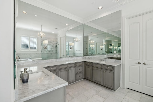 bathroom with vanity, a chandelier, a shower stall, and ornamental molding