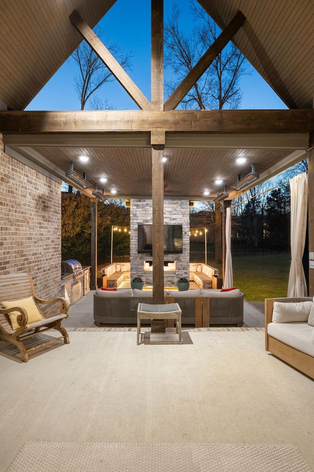 view of patio / terrace featuring grilling area, area for grilling, and an outdoor living space with a fireplace