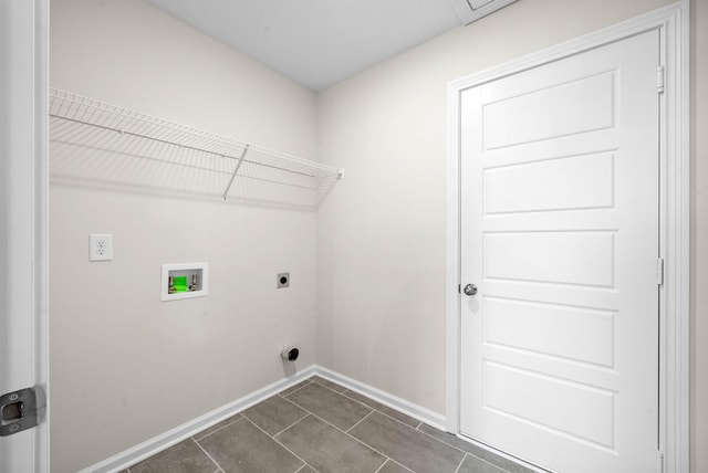 laundry room with hookup for a washing machine, hookup for an electric dryer, laundry area, dark tile patterned floors, and baseboards